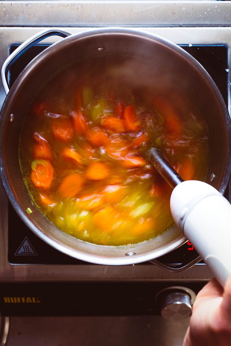 blending carrot soup using stick blender